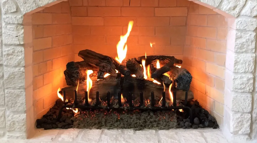 fireplace with fire on logs