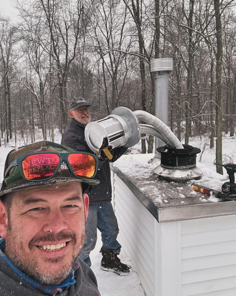 Newtown Fireplace Shop employees doing chimney repair