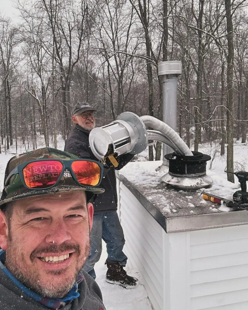 Newtown Fireplace Shop employees doing chimney repair